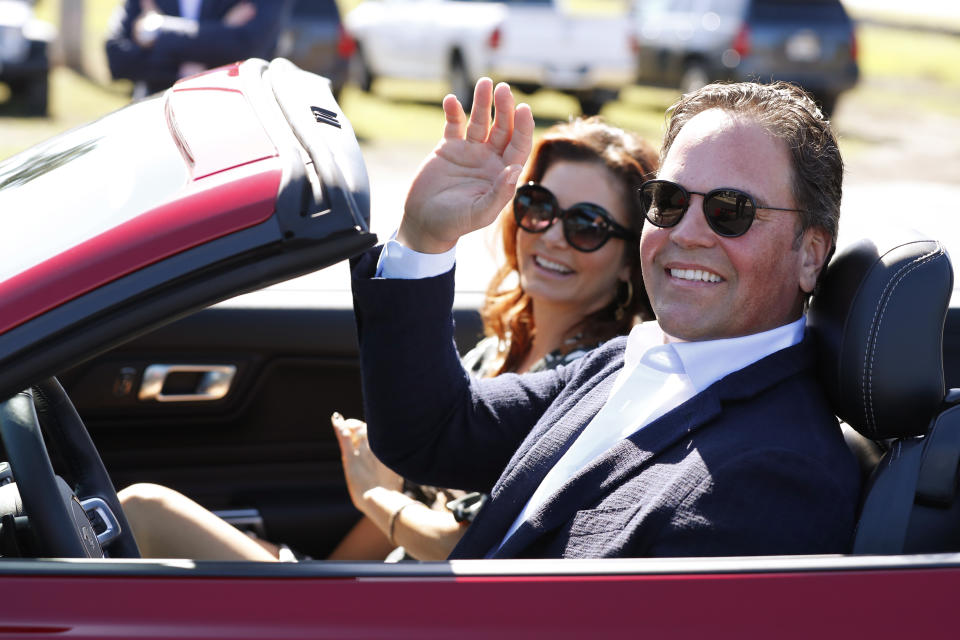 Former New York Mets catcher Mike Piazza and his wife Alicia wave as they drive down newly named Piazza Dr., after a ceremony in front of the Mets spring training facility, Thursday, Jan. 16, 2020, in Port St. Lucie, Fla. (AP Photo/Wilfredo Lee)