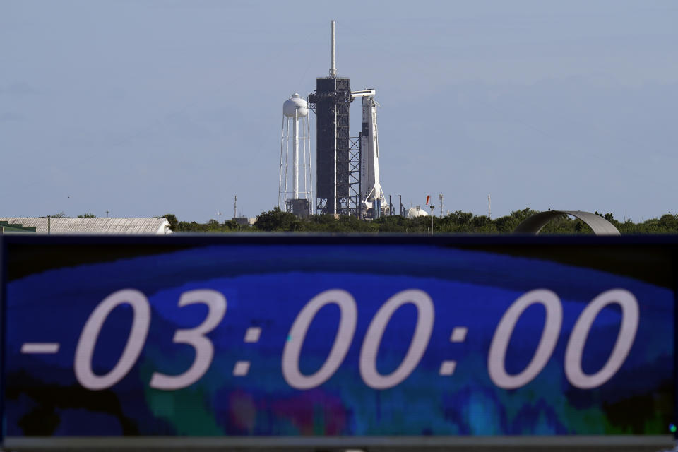 The countdown clock is stopped at a three-hour built in hold as a SpaceX Falcon 9 rocket, with the company's Crew Dragon capsule attached, sits on the launch pad at Launch Complex 39A Sunday, Nov. 15, 2020, at the Kennedy Space Center in Cape Canaveral, Fla. Four astronauts will fly on the SpaceX Crew-1 mission to the International Space Station scheduled for launch on later today. (AP Photo/Chris O'Meara)