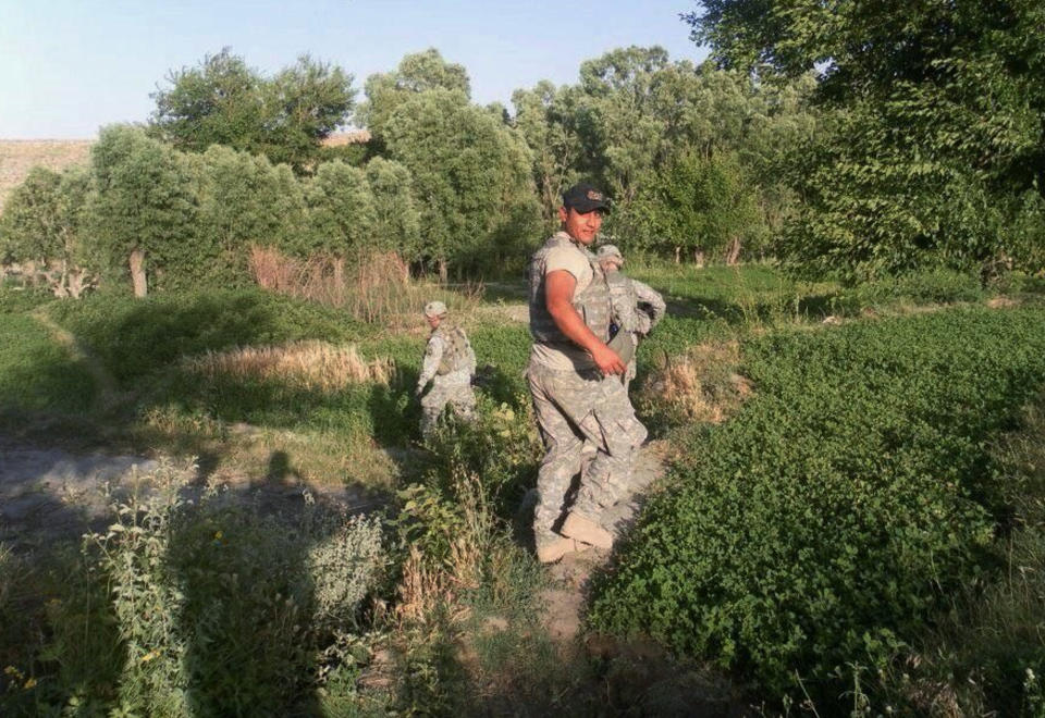 This 2010 photo provided by U.S. Army Capt. Matthew Ball shows his interpreter Qismat Amin in Nangarhar province of Afghanistan. Amin, who has been living in hiding after getting threats from Taliban and Islamic state fighters, got his visa Sunday, Jan. 29, 2017, after nearly four years of interviews. Ball bought him a $1,000 plane ticket to San Francisco and plans to meet him at the airport with an attorney. Ball said he has bought a plane ticket for his Afghan translator in case that country is added to the list of banned nations. (Matthew Ball via AP)