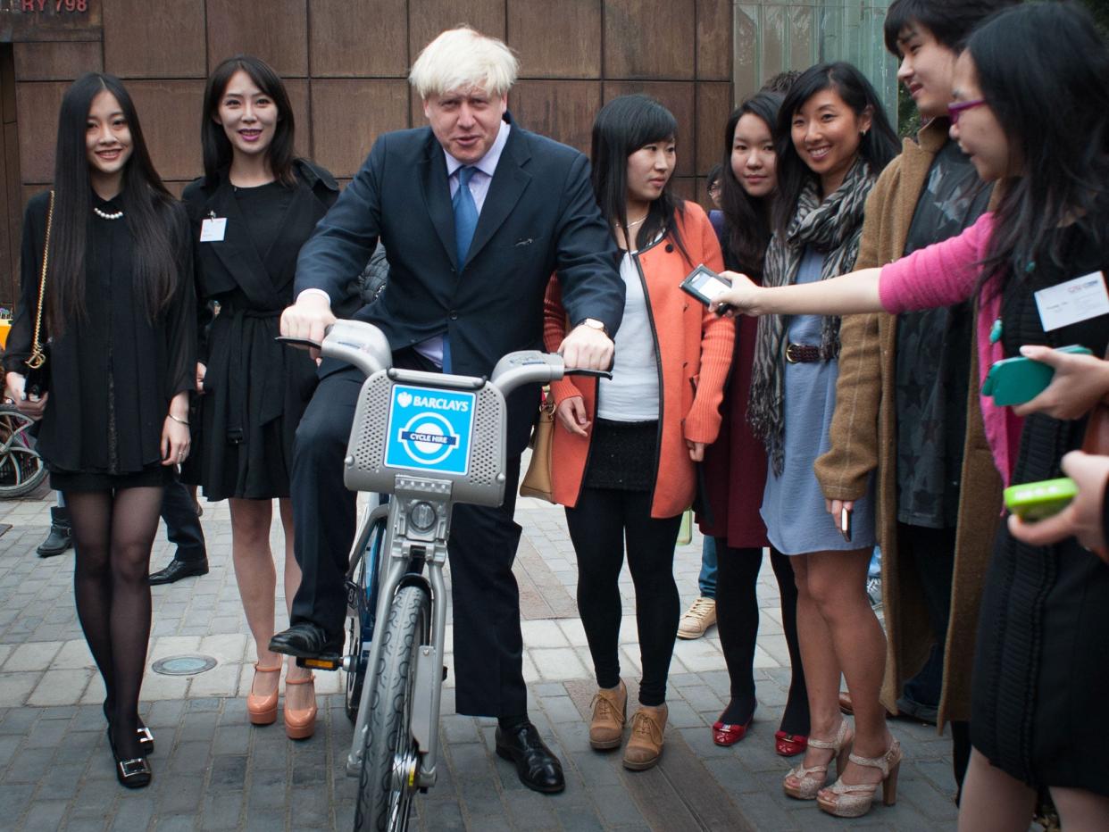 London Mayor Boris Johnson rides a 'Boris Bike' as he begins a six-day trade mission, meeting Chinese students at the London Universities International Partnership Showcase event in Beijing: PA