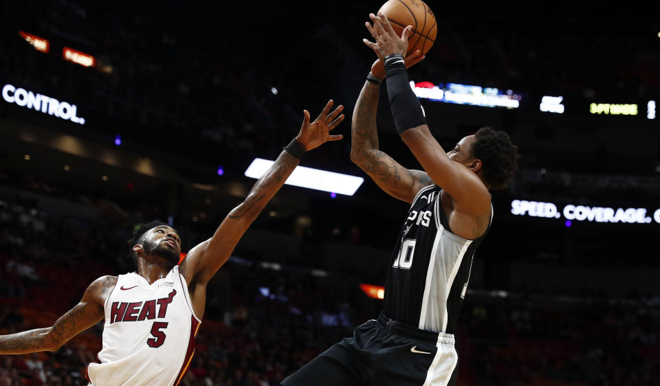 San Antonio Spurs guard DeMar DeRozan (10) shoots the ball against Miami Heat forward Derrick Jones Jr. (5) during the first half of an NBA preseason basketball game Tuesday, Oct. 8, 2019, in Miami. (AP Photo/Brynn Anderson)