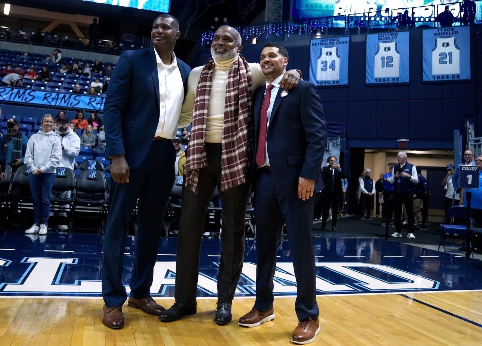 Former URI basketball players, from left, Antonio Reynolds Dean, Cuttino Mobley and Tyson Wheeler pose in front of their jerseys during the Ring of Honor ceremony.