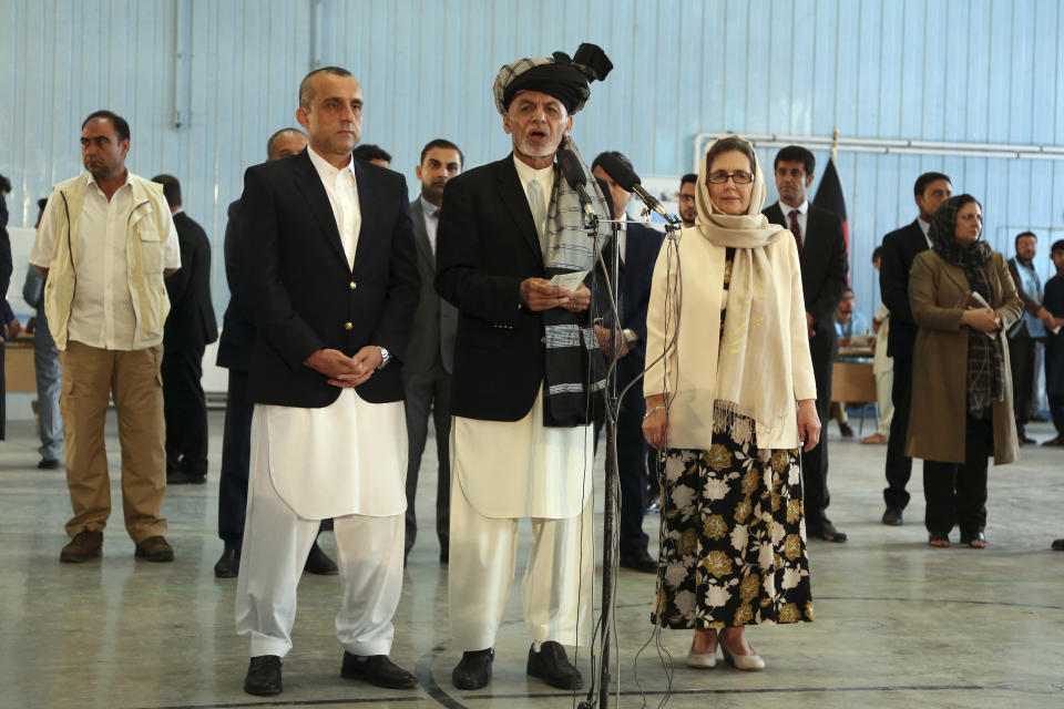 Afghan President Ashraf Ghani, center, speaks to journalists after voting at Amani high school, near the presidential palace in Kabul, Afghanistan, Saturday, Sept. 28, 2019. Afghans headed to the polls on Saturday to elect a new president amid high security and Taliban threats to disrupt the elections, with the rebels warning citizens to stay home or risk being hurt. (AP Photo/Rahmat Gul)