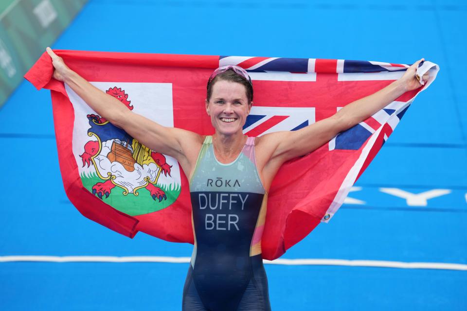 Jul 27, 2021; Tokyo, Japan; Flora Duffy (BER) celebrates after winning the women's triathlon during the Tokyo 2020 Olympic Summer Games at Odaiba Marine Park. Mandatory Credit: Kirby Lee-USA TODAY Sports