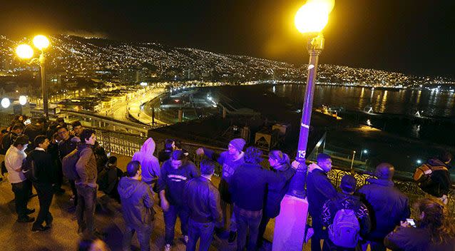 Santiago residents watch the sea in Chile after a powerful quake. Photo: Reuters