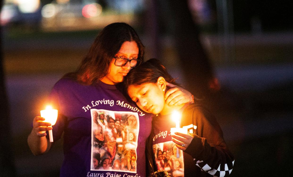 Angelina and Jayden Candia, the sisters of Laura Candia, 20, attend a candlelight vigil held by The Shelter for Abused Women & Children at the Immokalee Library in Immokalee on Thursday, Oct. 26, 2023. Candia was shot and killed on Sept. 16, 2023, in what authorities say was a domestic violence incident.
