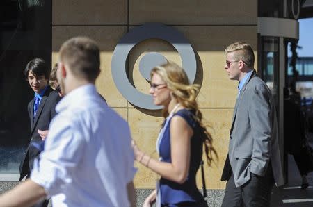 Pedestrians walk past Target headquarters after Target announced that 3,100 positions would be eliminated, in Minneapolis, Minnesota March 10, 2015. REUTERS/Craig Lassig