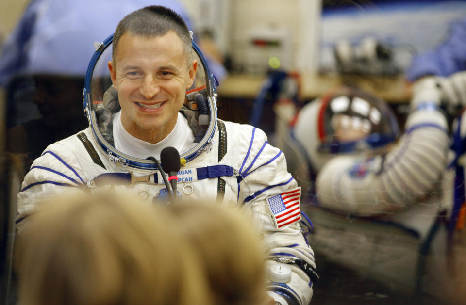 U.S. astronaut Andrew Morgan, speaks with his relatives through the safety glass prior the launch of Soyuz-FG rocket at the Russian leased Baikonur cosmodrome, Kazakhstan, Saturday, July 20, 2019. (AP Photo/Dmitri Lovetsky)