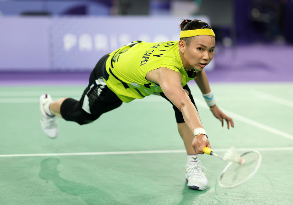 PARIS, FRANCE - JULY 31:  Tzu Yin Tai of Team Chinese Taipei plays a backhand as she competes against Ratchanok Intanon of Team Thailand during the Badminton Women's Singles Group Play Stage match on day five of the Olympic Games Paris 2024 at Porte de La Chapelle Arena on July 31, 2024 in Paris, France. (Photo by Lintao Zhang/Getty Images)