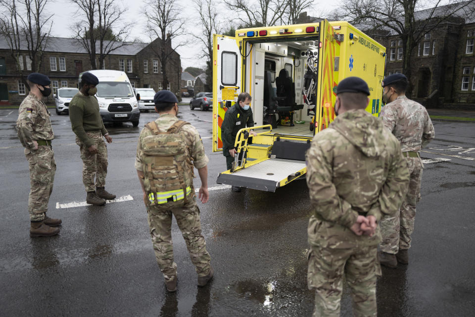 CARDIFF, WALES - DECEMBER 23: Members of the military practice loading and unloading a stretcher into an ambulance at Maindy Barracks on December 23, 2020 in Cardiff, Wales. The Welsh Ambulance Service has called on the army to help as it deals with acute pressure on its service. More than 90 soldiers will be drafted in from today to help drive their emergency vehicles as the second wave of the coronavirus pandemic continues to take hold on the NHS. Members of the 9th Regiment Royal Logistic Corps, 1st Armoured Medical Regiment, RAMC (Royal Army Medical Corps) and the 4th and 5th Armoured Medical Regiment will provide assistance. Wales has had more Covid-19 cases in the last seven days relative to its population than any other country in the world except Lithuania. (Photo by Matthew Horwood/Getty Images)