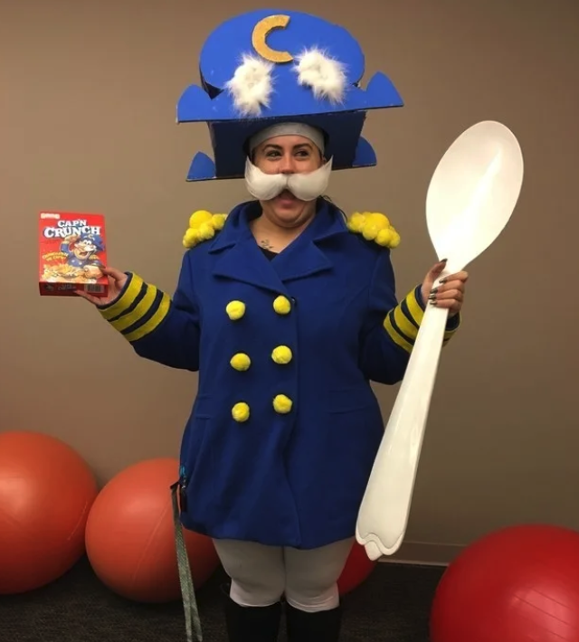 Someone dressed as Cap'N crunch while holding a giant spoon