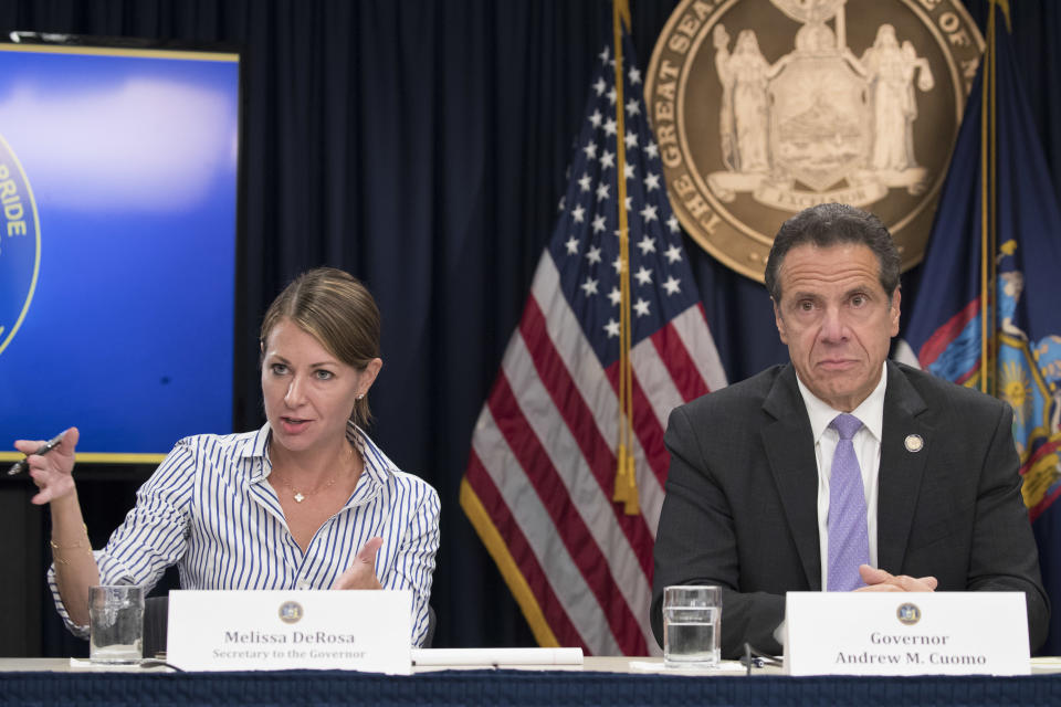 FILE — In this Sept. 14, 2018 file photo, Secretary to the Governor Melissa DeRosa, is joined by New York Gov. Andrew Cuomo as she speaks to reporters during a news conference, in New York. De Rosa, Cuomo's top aide, told top Democrats frustrated with the administration's long-delayed release of data about nursing home deaths that the administration "froze" over worries about what information was "going to be used against us," according to a Democratic lawmaker who attended the Wednesday, Feb. 10, 2021 meeting and a partial transcript provided by the governor's office. (AP Photo/Mary Altaffer, File)