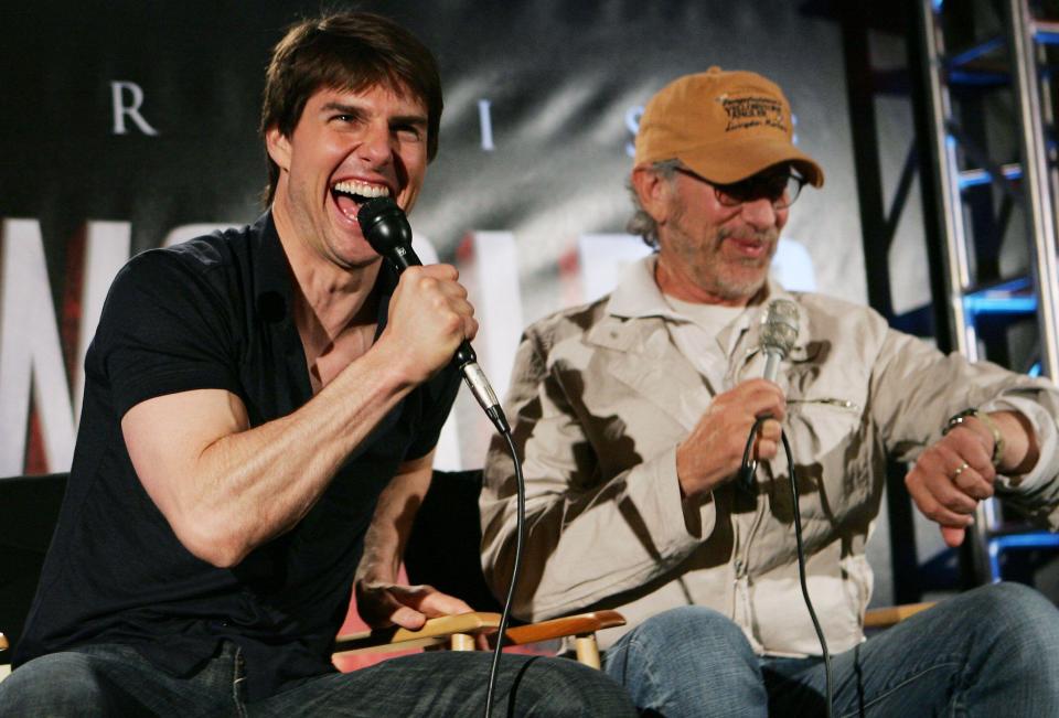 Actor Tom Cruise (L) and director Steven Spielberg share a laugh as they appear at a news conference together as part of the promotion of their new sci-fi adventure film 