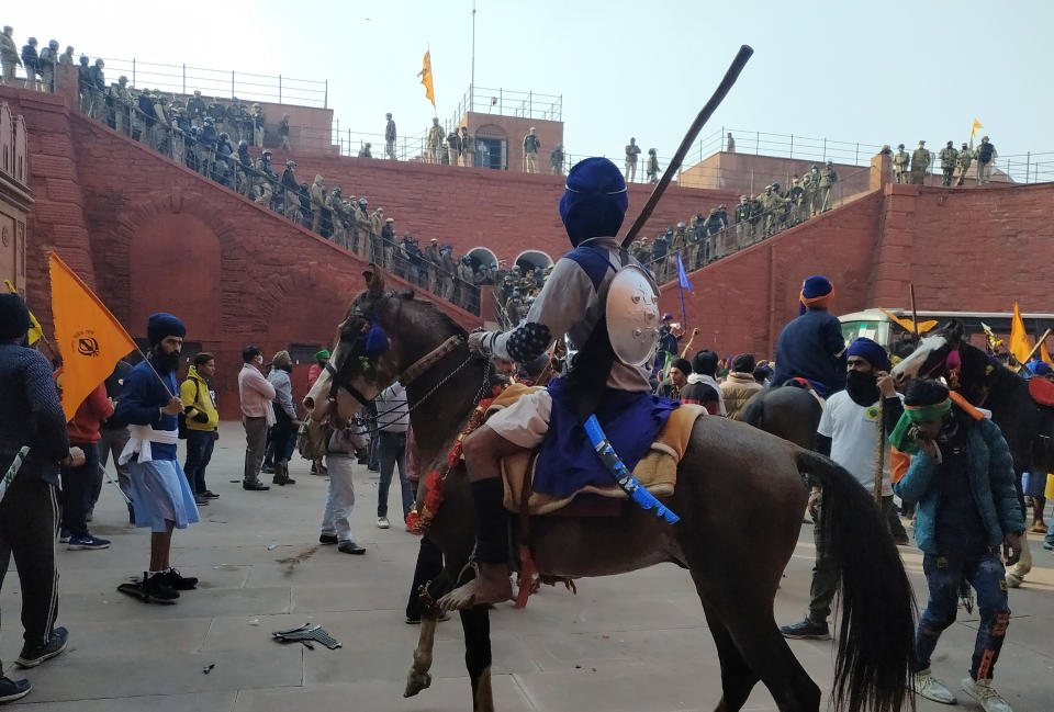 NEW DELHI, INDIA - JANUARY 26: Nihang Sikhs at Red Fort during the farmers' tractor rally on Republic Day, on January 26, 2021 in New Delhi, India. Major scenes of chaos and mayhem at Delhi borders as groups of farmers allegedly broke barricades and police check posts and entered the national capital before permitted timings. Police used tear gas at Delhi's Mukarba Chowk to bring the groups under control. Clashes were also reported at ITO, Akshardham. Several rounds of talks between the government and protesting farmers have failed to resolve the impasse over the three farm laws. The kisan bodies, which have been protesting in the national capital for almost two months, demanding the repeal of three contentious farm laws have remained firm on their decision to hold a tractor rally on the occasion of Republic Day.(Photo by Sanjeev Verma/Hindustan Times via Getty Images)