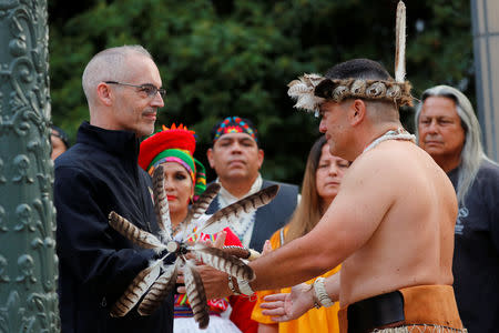 Los Angeles City Council member Mitch O'Farrell (L) is presented a running staff by Kevin Nunez of the Gabrielino-Tongva tribe during a sunrise ceremony after Los Angeles City Council voted to establish the second Monday in October as "Indigenous People's Day", replacing Columbus Day, in Los Angeles, California, U.S., October 8, 2018. REUTERS/Mike Blake