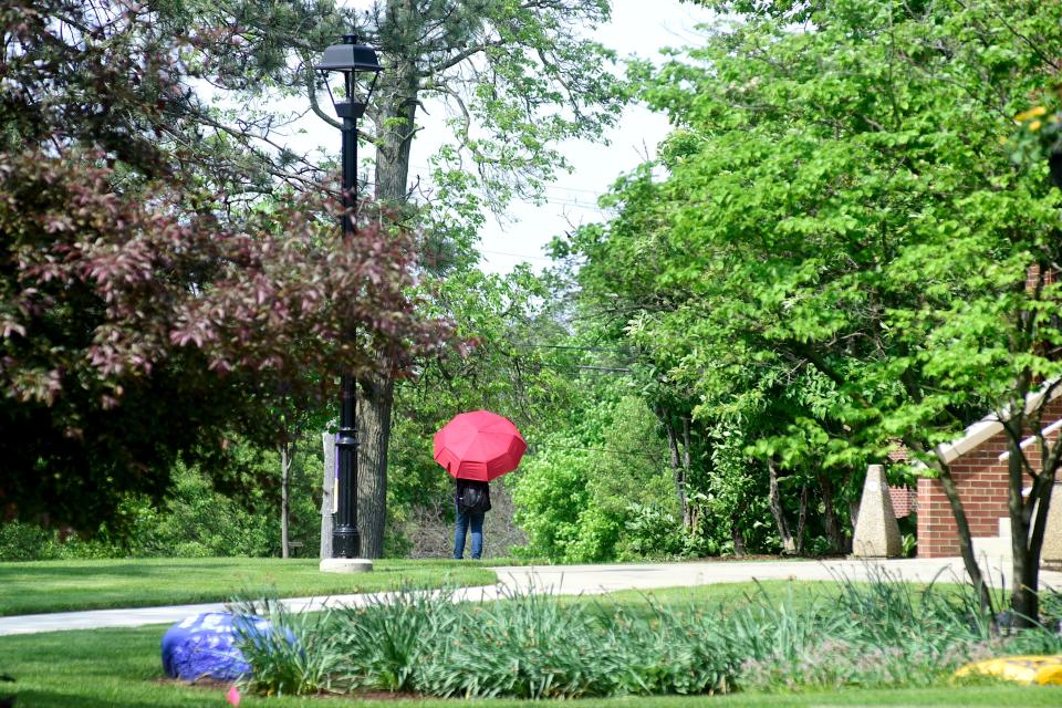 A student walks through the AU campus