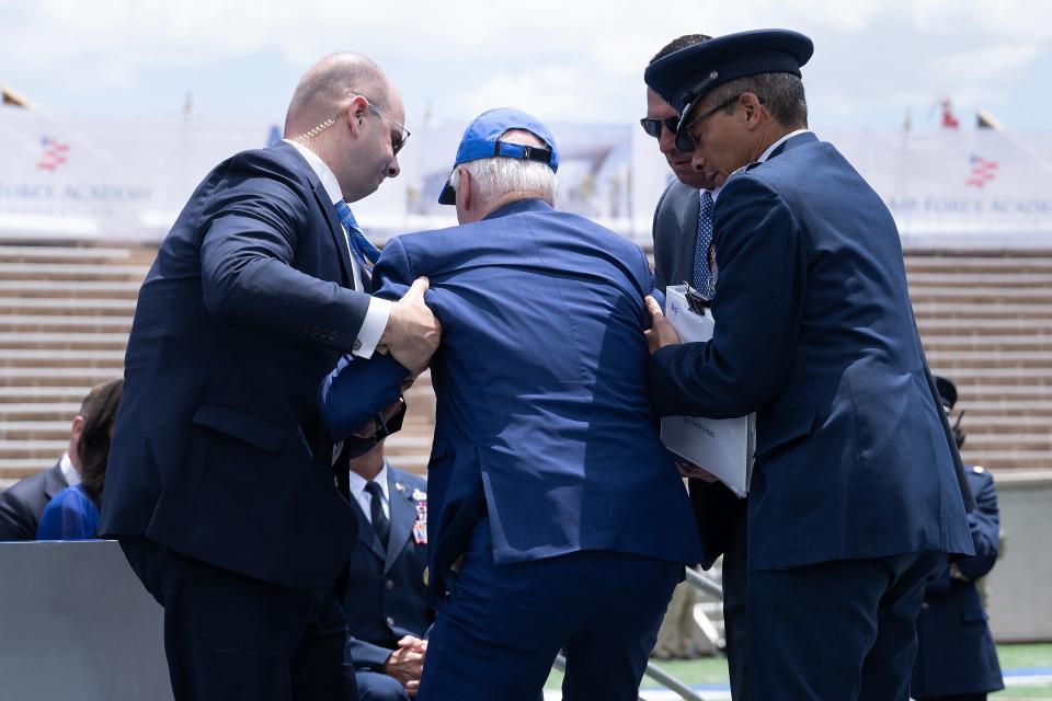 US President Joe Biden is helped up after falling during the graduation ceremony at the United States Air Force Academy, just north of Colorado Springs in El Paso County, Colorado, on June 1, 2023. (Photo by Brendan Smialowski / AFP) (Photo by BRENDAN SMIALOWSKI/AFP via Getty Images)