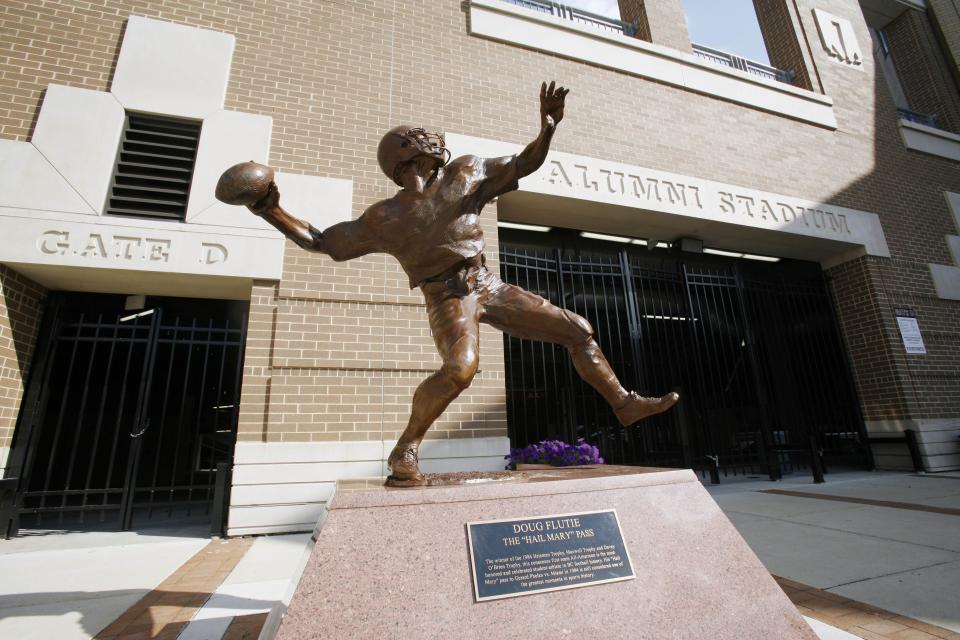 FILE - A statue commemorating Doug Flutie's famed "Hail Mary" pass during an NCAA college football game is seen outside Alumni Stadium at Boston College in Boston on Aug. 14, 2009. Famous football plays often attain a legendary status with religious names like the "Immaculate Reception," the "Hail Mary" pass and the Holy Roller fumble. (AP Photo/Michael Dwyer, File)