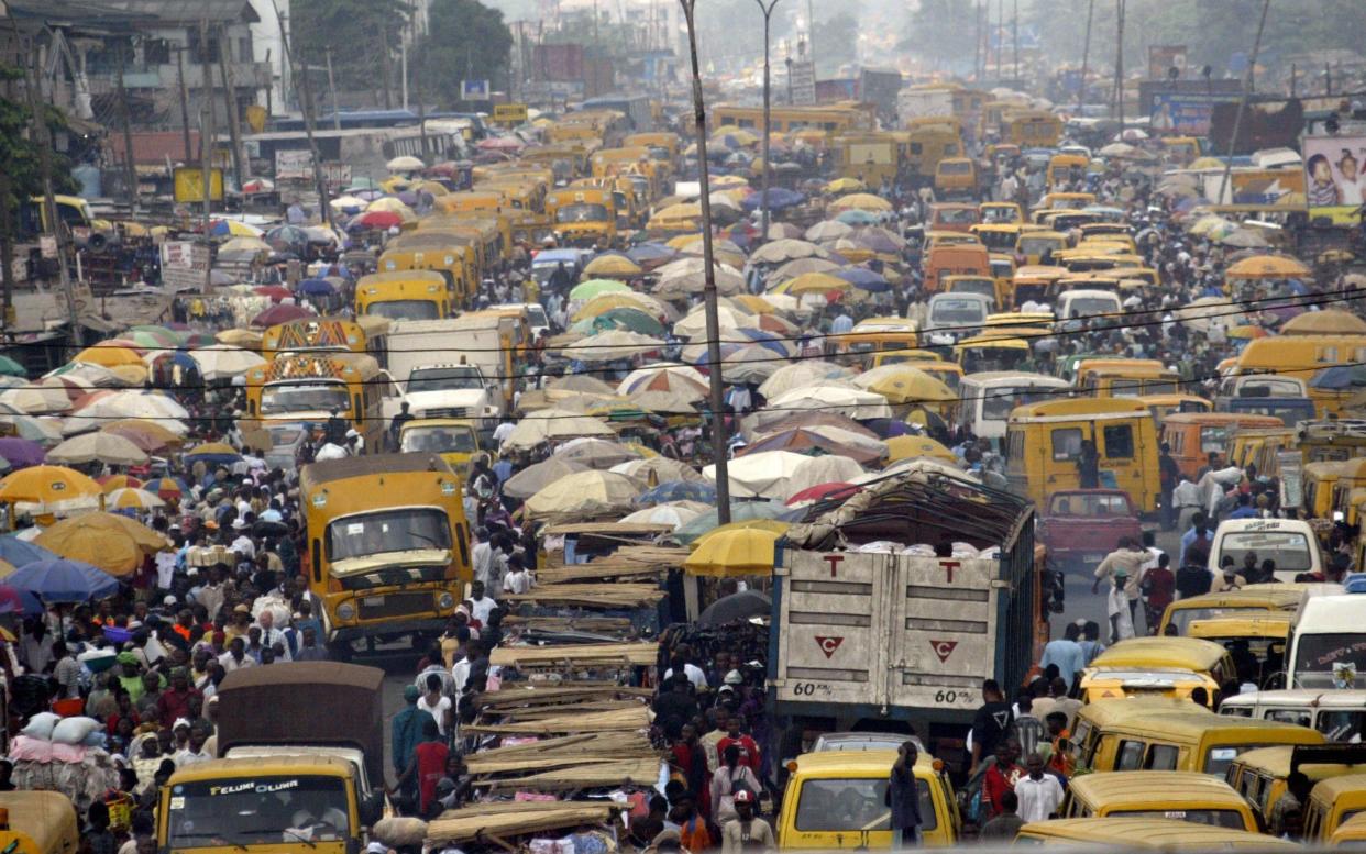 People and trucks jostle for space in Lagos, Nigeria - one of the world's most densely populated cities - AFP