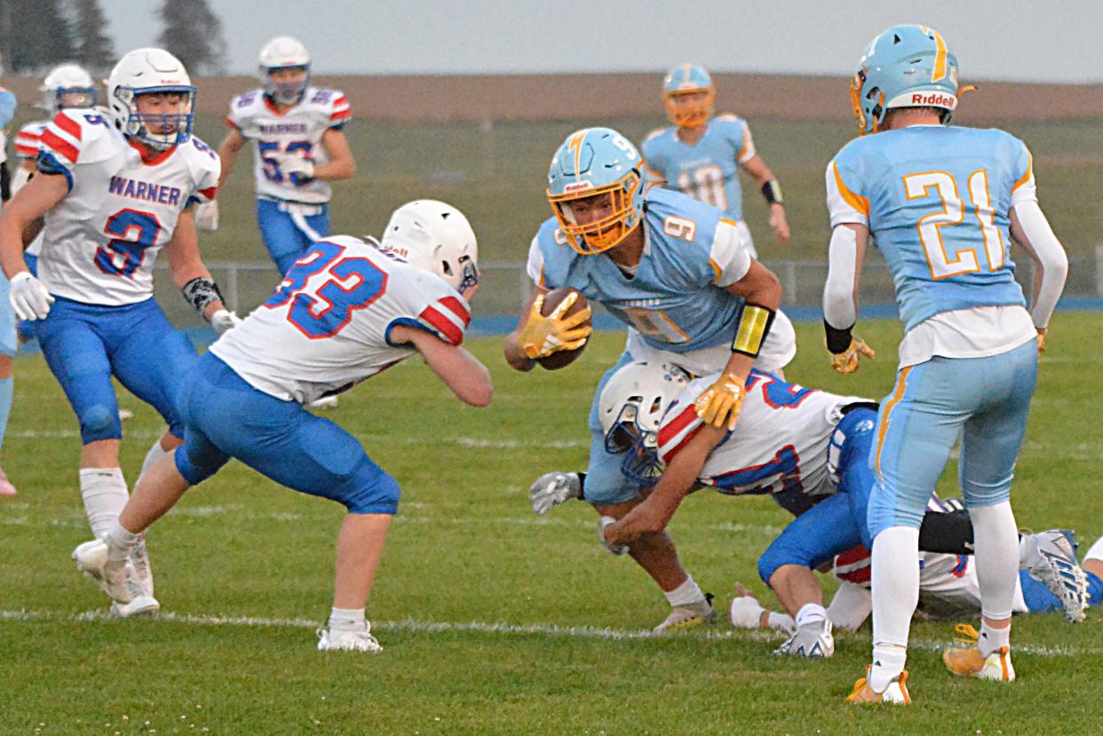 Warner's Payton Volk (21) and Charlie Dulany (33) combine to bring down Hamlin's Zac VanMeeteren after he made a catch during their high school football game on Friday, Sept. 29, 2023 in Hayti. Also pictured are Warner's Brodey Sauerwein (3) and Hamlin's Turner Stevenson (21). No. 1 Class 9A Warner beat No. 2 Class 9AA Hamlin 22-13.