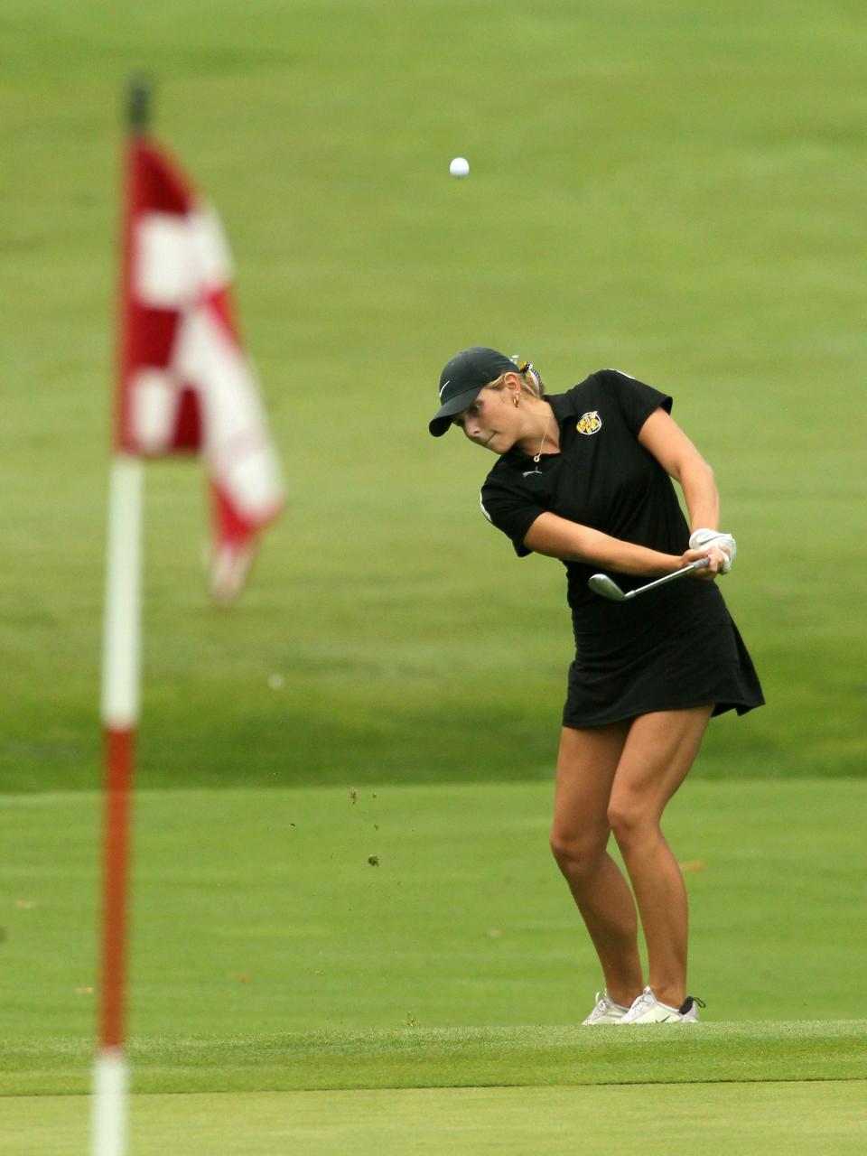 Watkins Memorial's Gracie James chips onto the green at hole 7 during the Licking County League girls golf tournament at Cumberland Trail.