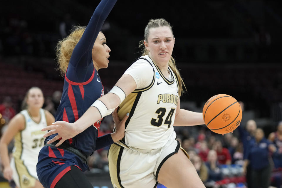 Purdue forward Caitlyn Harper (34) drives on St. John's forward Rayven Peeples (20) in the second half of a First Four women's college basketball game in the NCAA Tournament Thursday, March 16, 2023, in Columbus, Ohio. (AP Photo/Paul Sancya)