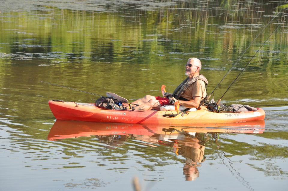 Rich Campbell cruises in his kayak to a fishing spot at the pond at Delaware City dikes July 11. Campbell said he's been fishing at the site on Cox Neck Road west of Delaware City for about 50 years and was disappointed to learn it's scheduled to be drained.