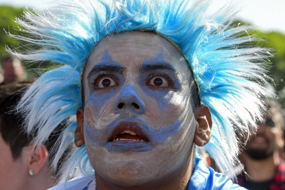 An Argentina soccer fan watches the team lose to Saudi Arabia at a World Cup Group C soccer match, played on a large screen in the Palermo neighborhood of Buenos, Aires, Argentina, early Tuesday, Nov. 22, 2022. (AP Photo/Gustavo Garello)