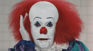 Tim Curry as Pennywise waving