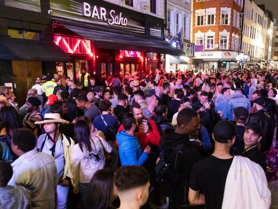 Revellers drink and socialise in the street after pubs and bars reopen after coronavirus lockdown in Soho, London, 4 July 2020: Vickie Flores/EPA