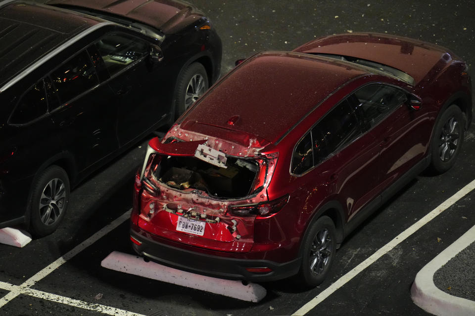 A damaged vehicle is seen in the parking lot of the Sandman Signature hotel following an explosion, Monday, Jan. 8, 2024, in Fort Worth, Texas. (AP Photo/Julio Cortez)