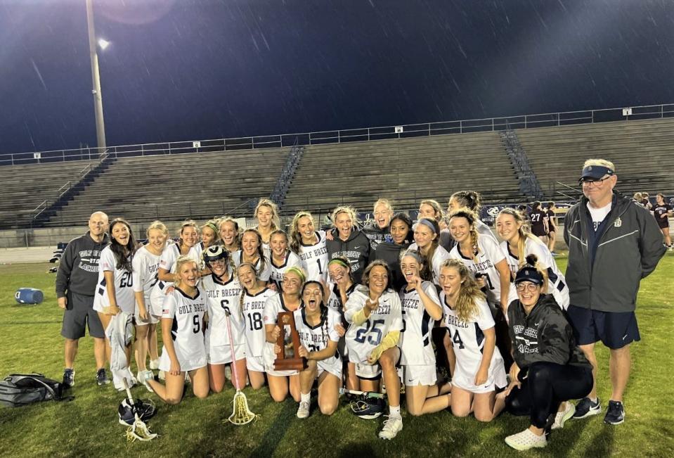 The Gulf Breeze girls lacrosse team celebrates its District 1-2A title after defeating Niceville 7-4 on Wednesday, April 12, 2023 from Dolphin Stadium.