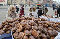 <p>A street vendor offers doughnuts in Warsaw, Poland, Feb. 23, 2017. The last Thursday of the Carnival is traditionally called in Poland Fat Thursday, the day on which people eat cakes, preferably doughnuts. (Photo: Alik Keplicz/AP) </p>