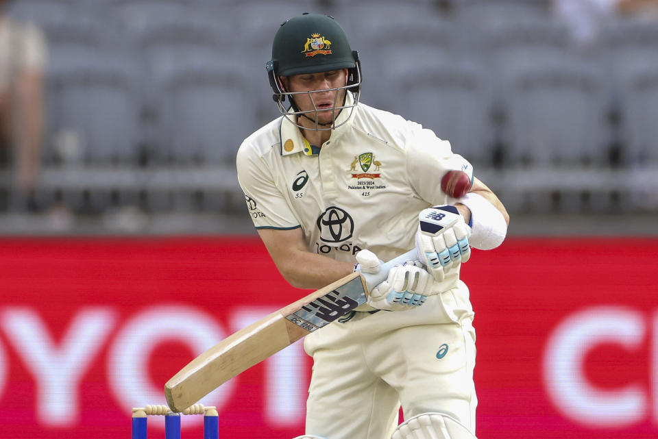 Steve Smith of Australia reacts as he is struck on the arm while batting during play on the third day of the first cricket test between Australia and Pakistan in Perth, Australia, Saturday, Dec. 16, 2023. (Richard Wainwright/AAP Image via AP)