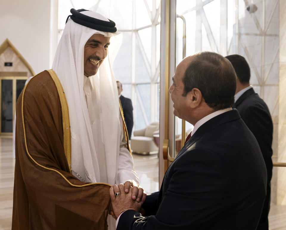 ADDS DETAILS OF VISIT -- In this photo released by the Qatar Amiri Diwan, Emir of Qatar Sheikh Tamim bin Hamad Al Thani, right, meets with Egyptian President Abdel-Fattah el-Sissi in Doha, Qatar, Tuesday, Sept. 13, 2022. Egypt’s president travelled on Tuesday to Qatar on his first visit to the gas-rich nation amid warming ties after years of frayed relations following the Egyptian military’s overthrow of an Islamist president backed by Doha. (Qatar Amiri Diwan via AP)