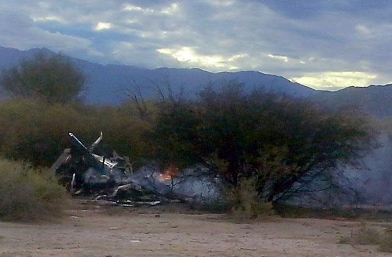 The burning wreckage of two helicopters which collided mid-air near Villa Castelli, in the Argentine province of La Rioja, on March 9, 2015