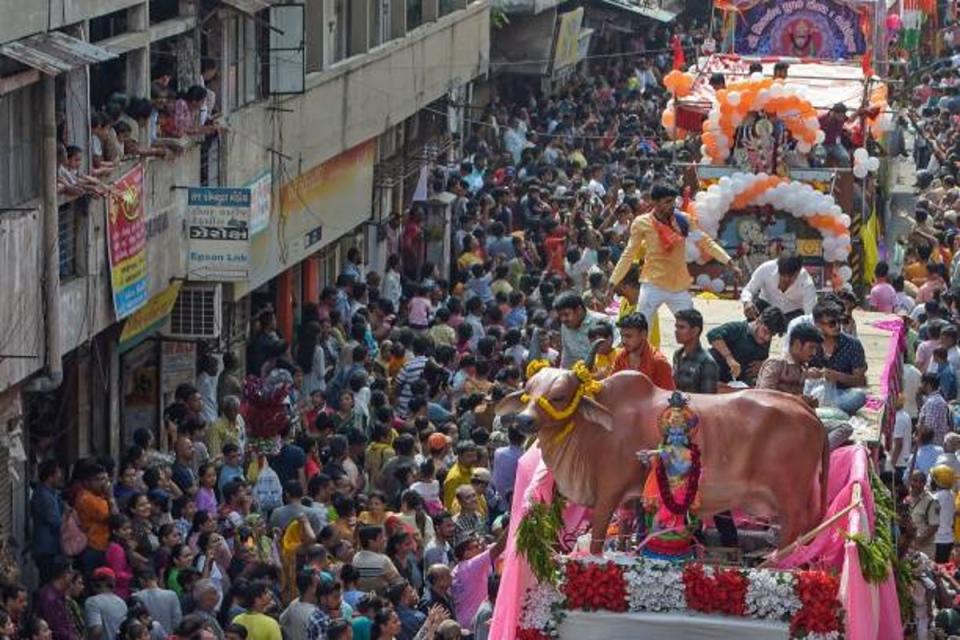 A tableau depicting the holy cow takes part in the annual religious procession on 20 June 2023 (AFP via Getty Images)