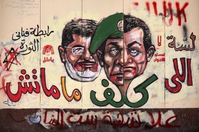 Graffiti depicting Egyptian President Mohamed Morsi (L), ousted president Hosni Mubarak (R) and former head of the army Field Marshal Mohammed Hussein Tantawi cover the walls outside the presidential palace in Cairo on December 8. Egypt's opposition was set to decide on further possible rallies in Cairo on Sunday, after Islamist President Mohamed Morsi announced a key concession