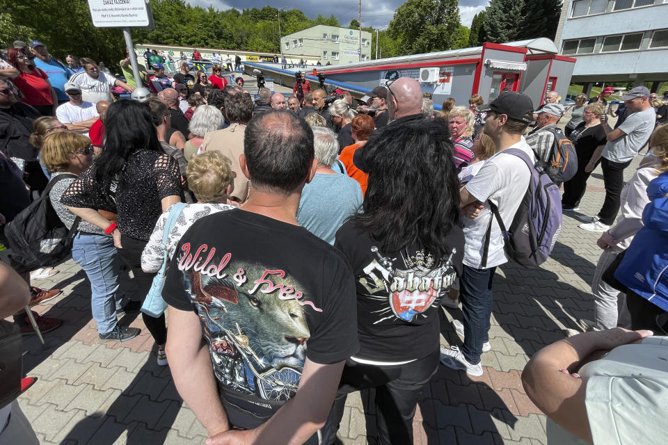 People gather outside the F. D. Roosevelt University Hospital, where Slovak Prime Minister Robert Fico, who was shot and injured, is being treated, in Banska Bystrica, central Slovakia, Saturday, May 18, 2024. The man accused of attempting to assassinate Slovak Prime Minister Robert Fico made his first court appearance Saturday as the nation's leader remained in serious condition recovering from surgery after surviving multiple gunshots, Slovak state media said. (AP Photo/Lefteris Pitarakis)