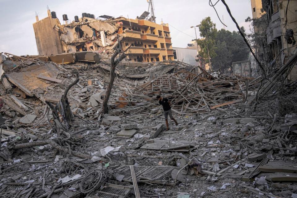 PHOTO: Palestinians inspect the rubble of a building after it was struck by an Israeli airstrike, in Gaza City, Oct. 8, 2023. (Fatima Shbair/AP)