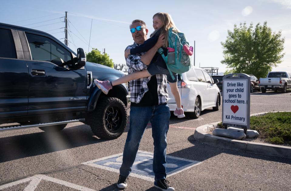 Eric Lillis, executive director of Kingman Academy of Learning, greets Aubree Bischoff after she is dropped off on April 26, 2023, at the Kingman Academy Primary School.