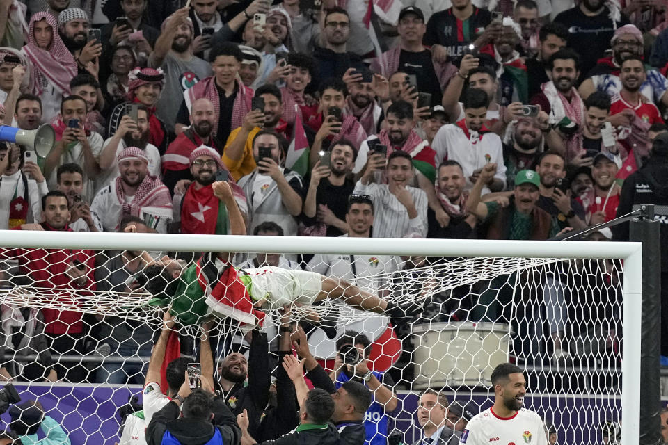 Jordan's Yazan Alnaimat celebrates with his team players after winning the Asian Cup Semi-finals soccer match between Jordan and South Korea at Ahmad Bin Ali Stadium in Al Rayyan, Qatar, Tuesday, Feb. 6, 2024. (AP Photo/Thanassis Stavrakis)