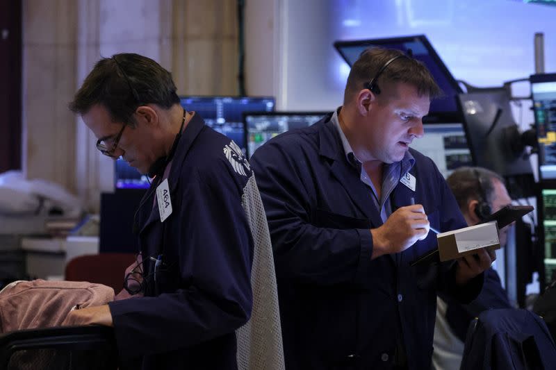 Traders work on the floor of the NYSE in New York