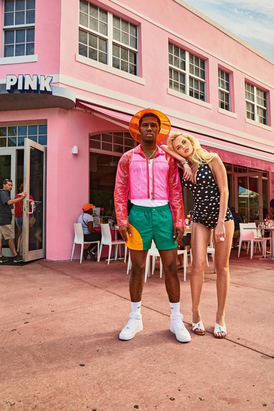 On Re'chard (left): Jacket, socks, hat, and necklace, his own / Tank top, $148, by Boss / Swim trunks, $180, by Kenzo / His own sneakers, by Nike | On Ksenia (right): Swimsuit, by Dolce & Gabbana / Shoes, by Clergerie / Bracelets, by Alexis Bittar / Ring, by Dinosaur Designs