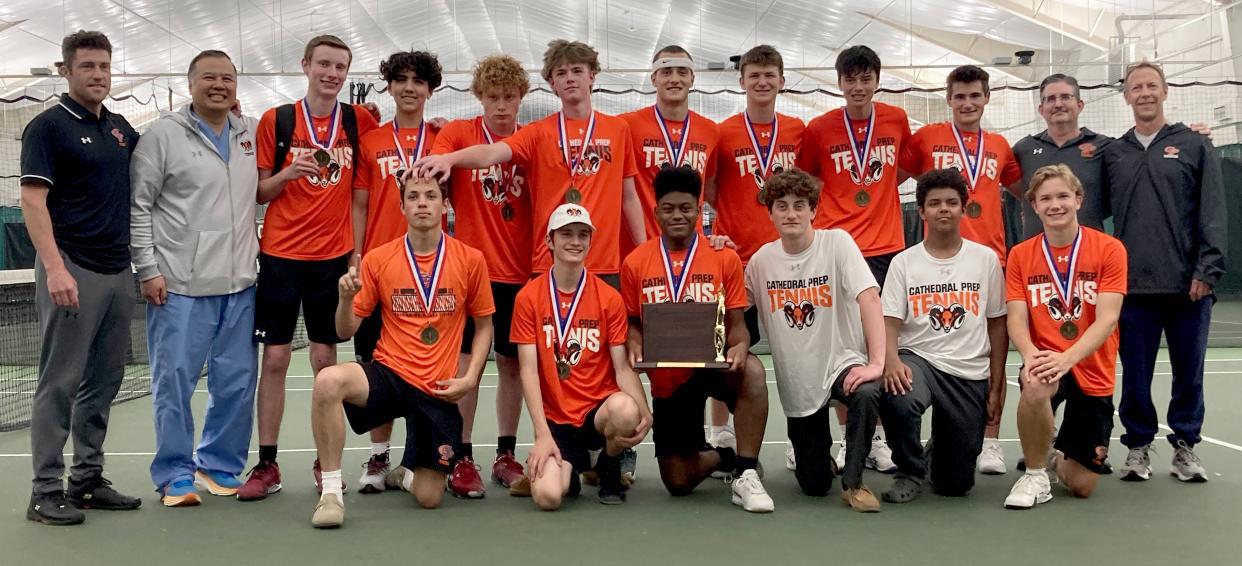 Players and coaches for Cathedral Prep's boys tennis team pose with District 10's championship trophy after winning its Class 3A tournament at Westwood Racquet Club. The Ramblers beat the Fairview Tigers 5-0 in Friday's final.