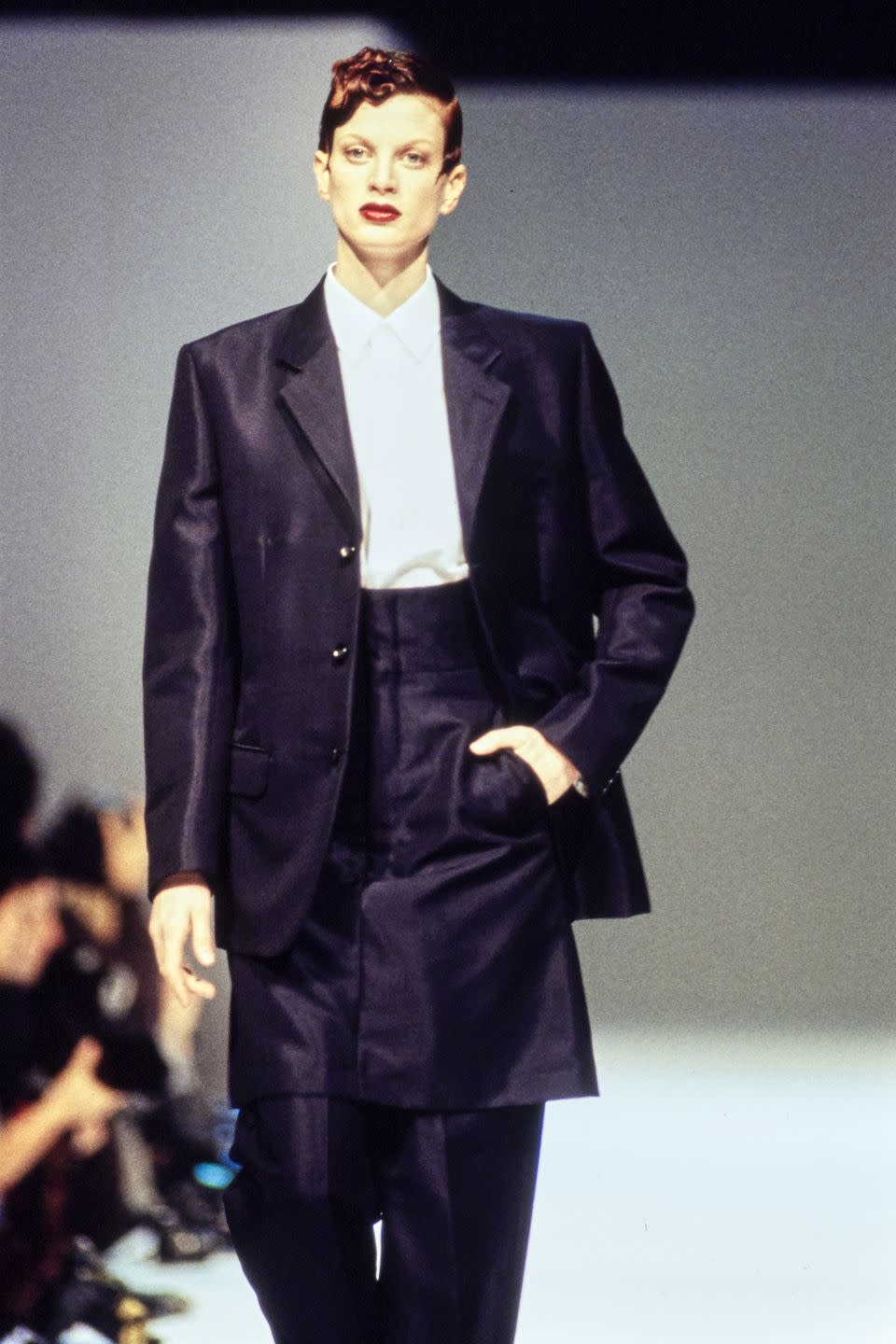 <p>Cited as an unconventional beauty, McMenamy was nonetheless celebrated for her androgyny. She thankfully didn't heed the advice of model agent Eileen Ford, who encouraged her to <a href="https://www.crfashionbook.com/celebrity/a25562079/remember-when-kristen-mcmenamy-eyebrows-birthday/" rel="nofollow noopener" target="_blank" data-ylk="slk:get plastic surgery;elm:context_link;itc:0;sec:content-canvas" class="link ">get plastic surgery</a>. From labels like Chanel, Versace, and Comme des Garçons to photographers like Steven Meisel and Juergen Teller, the fashion industry embraced the Pennsylvania native's uniqueness. </p>