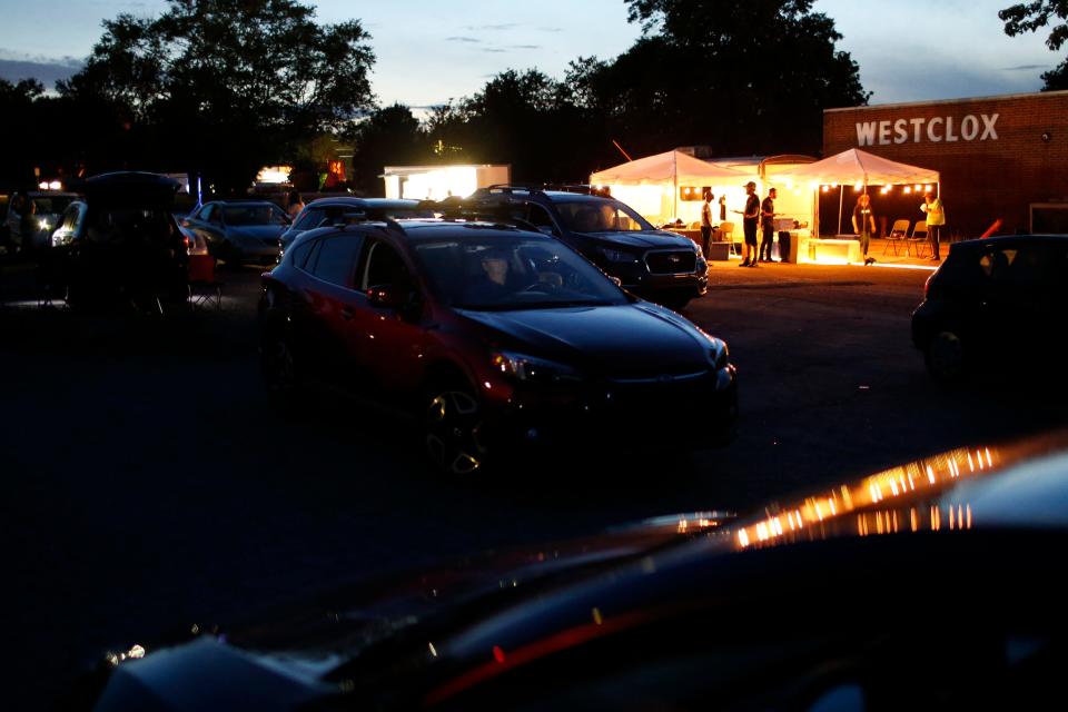 Moviegoers grab concessions and settle in as the sun sets at the opening night of Ciné’s drive-in movie theater in Athens, Ga., on Tuesday, June 1, 2021. The theater showed “Mad Max: Fury Road” to start out its summer drive-in movie theater shows with a sold-out parking lot at the General Time/Westclox clock factory on Newton Bridge Road.