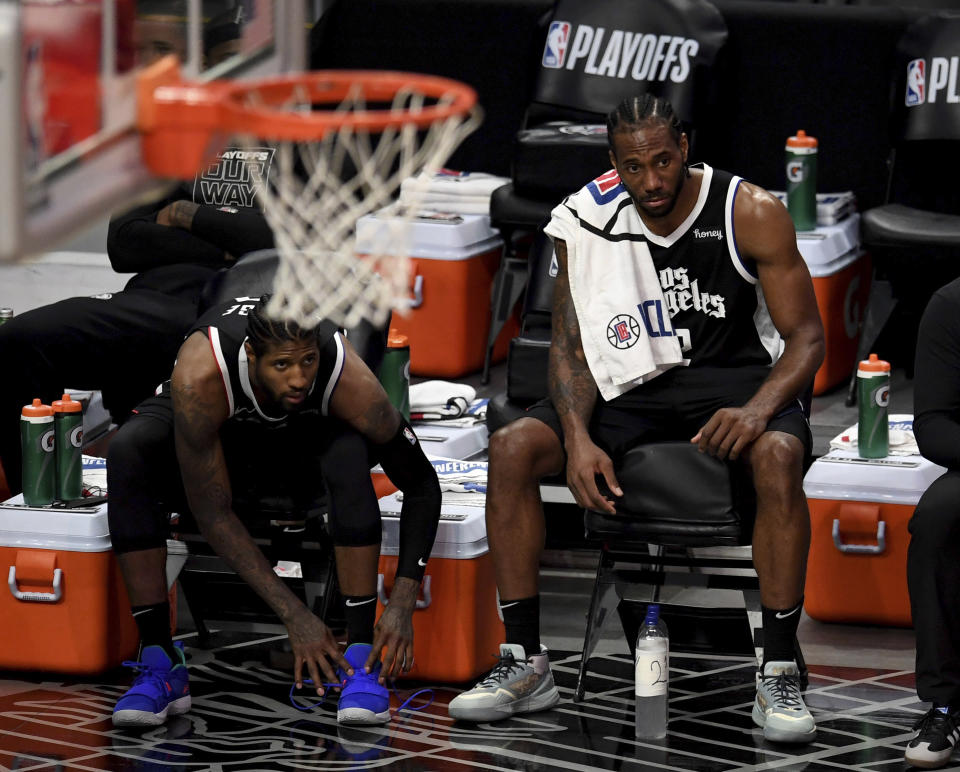 Paul George #13 along with teammate Kawhi Leonard #2 of the LA Clippers on the bench look on in the fourth quarter of game three of the Western Conference second-round NBA basketball playoff basketball game against the Utah Jazz at the Staples Center in Los Angeles on Saturday, June 12, 2021. (Keith Birmingham/The Orange County Register via AP)