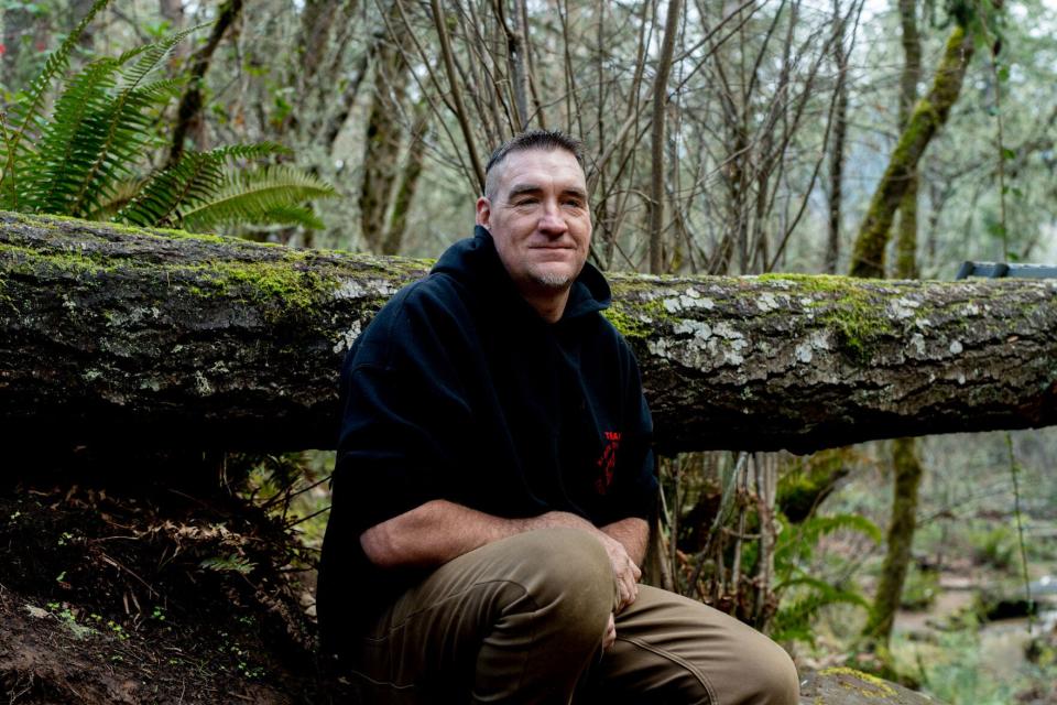 Scott Haury kneels along a pathway used for radio-controlled 'crawling' at the Black Diamond RC Ranch in Sutherlin.