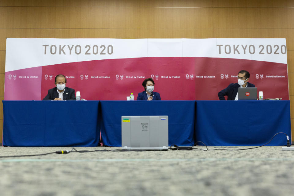 Tokyo 2020 CEO Toshiro Muto, left, and President Seiko Hashimoto, center attend the news conference after receiving a report from a group of infectious disease experts on Friday, June 18, 2021, in Tokyo. The experts including Shigeru Omi, head of a government coronavirus advisory panel, issued a report listing the risks of allowing the spectators and the measurements to prevent the event from triggering a coronavirus spread. (Yuichi Yamazaki/Pool Photo via AP)